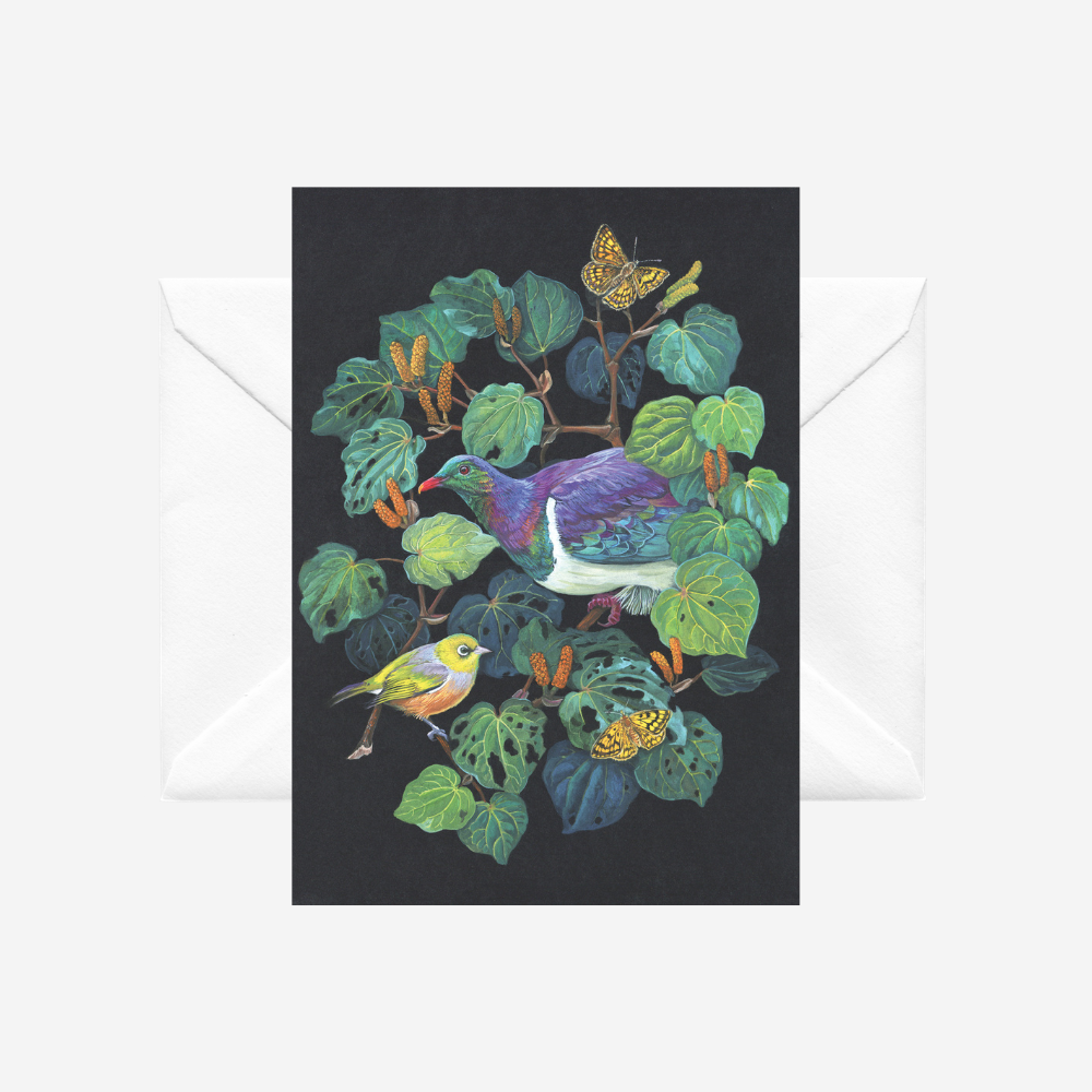 Greeting card with kereru and kawakawa on a black background, accompanied by a white envelope.