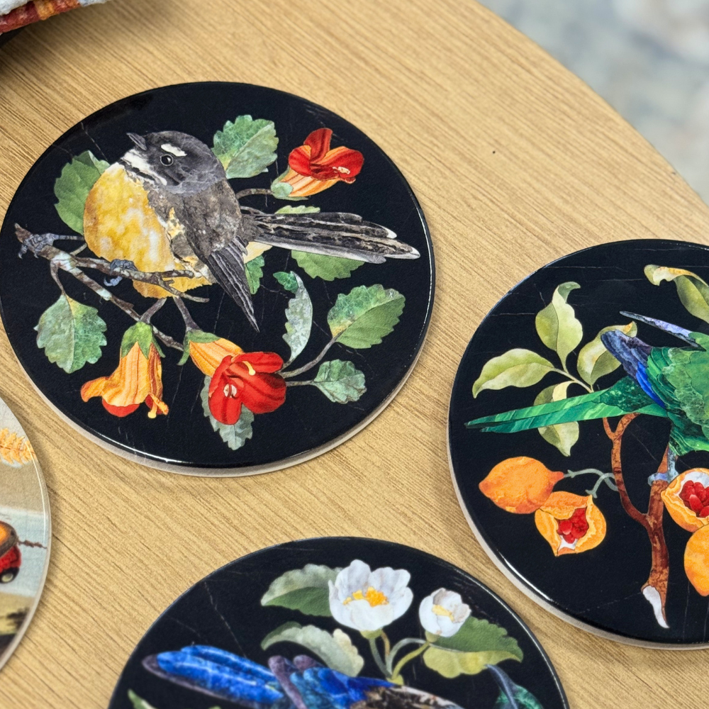 Decorative coasters with nature-themed designs on a wooden surface
