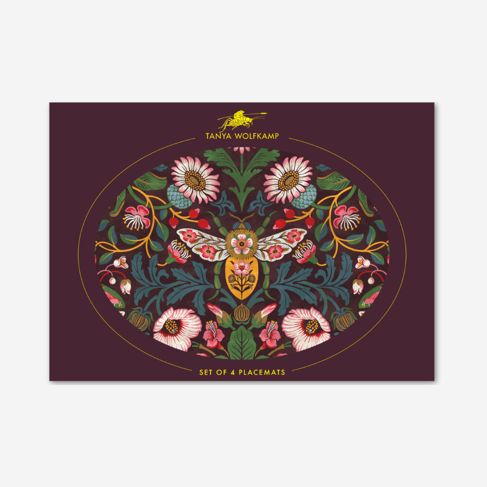 Decorative placemat with floral and butterfly design on a purple background, featuring the brand 'Tanya Wolfkamp'.