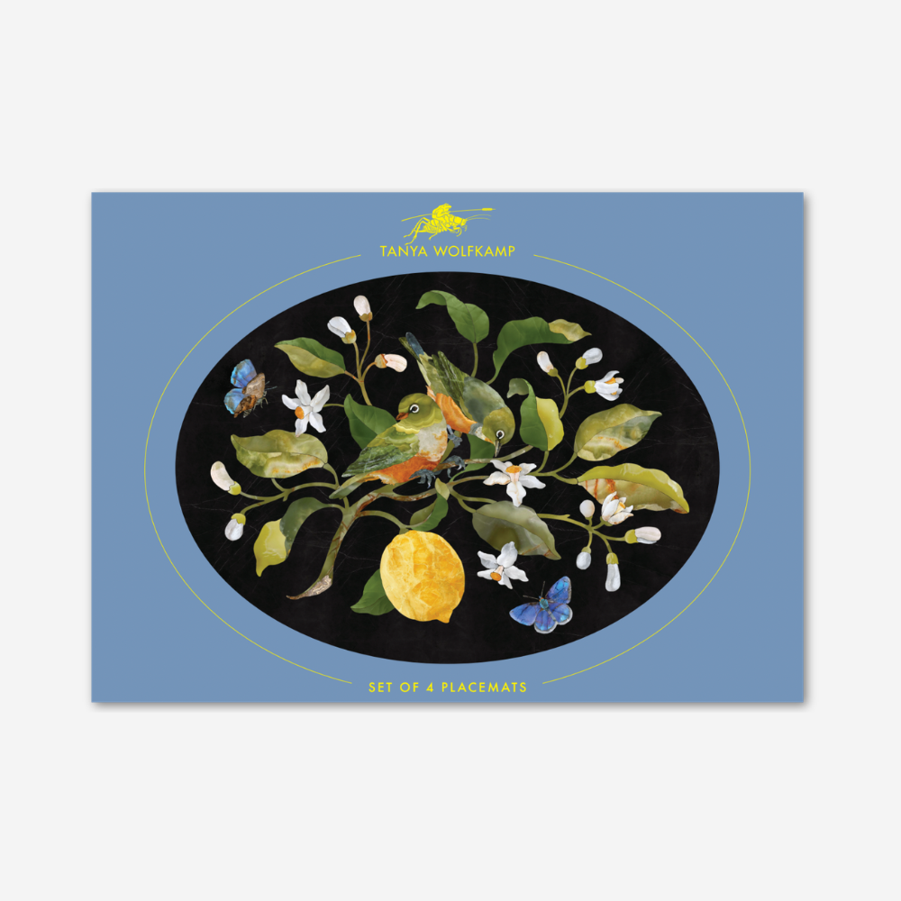 Placemat with nature-themed design featuring a bird, lemon, and flowers on a blue background.