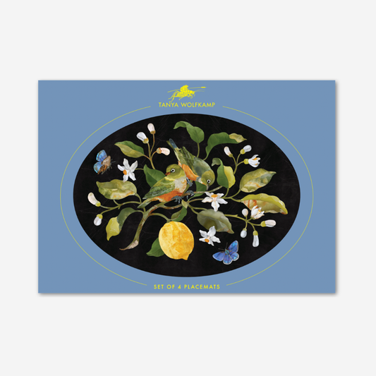 Placemat with nature-themed design featuring a bird, lemon, and flowers on a blue background.