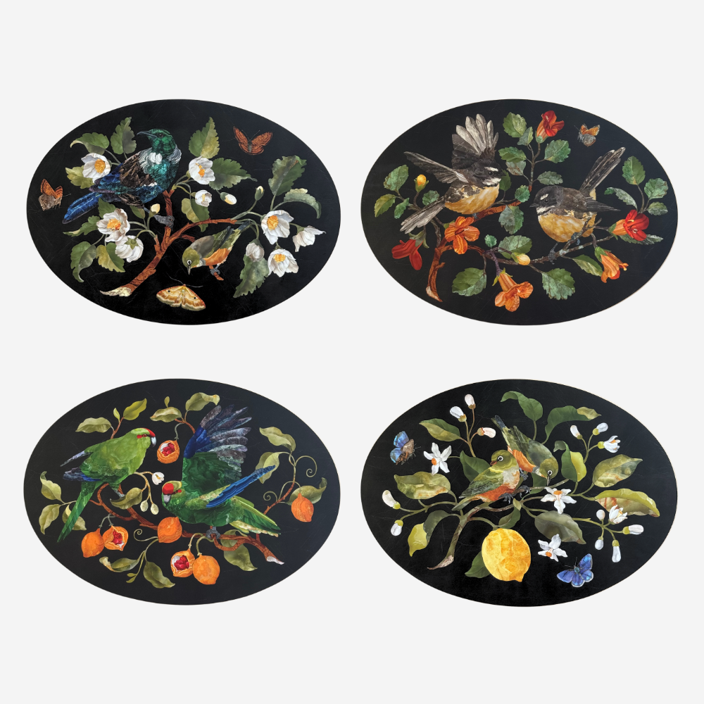 Set of four decorative coasters with bird and floral designs on a black background