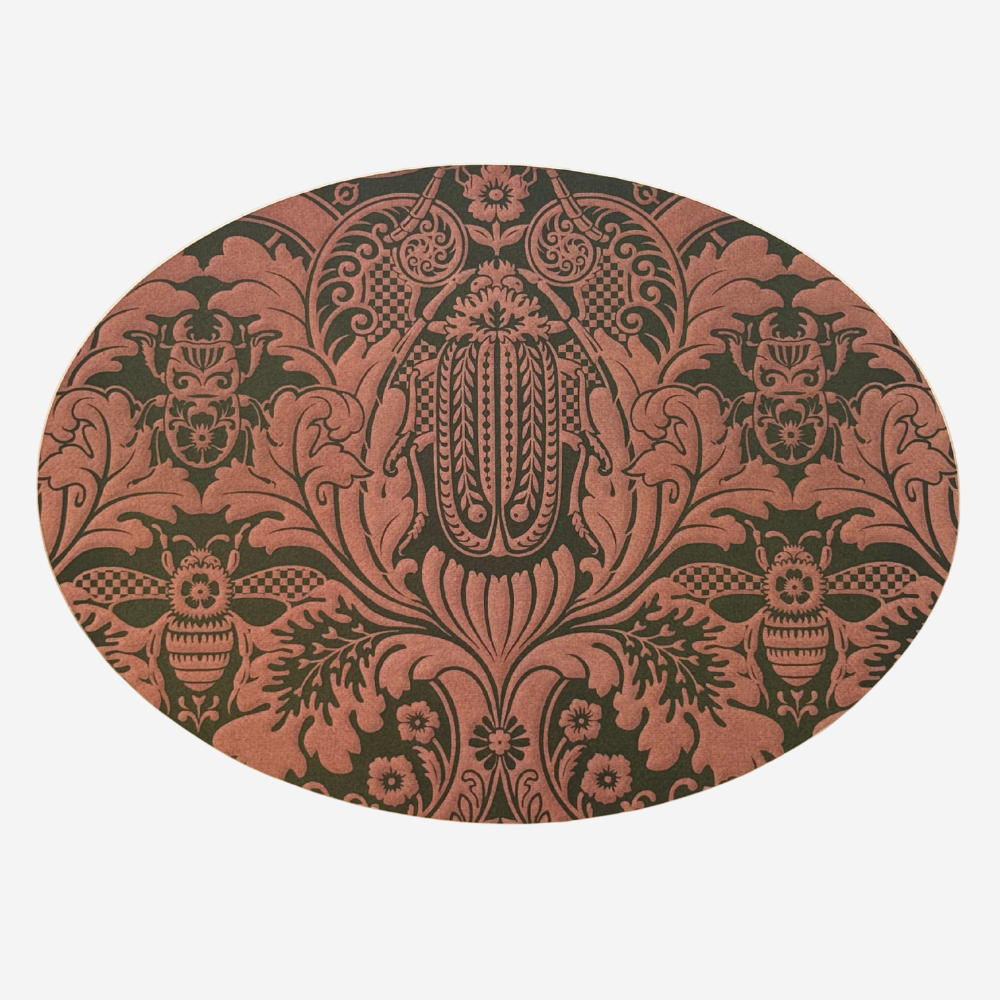 Decorative round mat with intricate black and red pattern on a white background