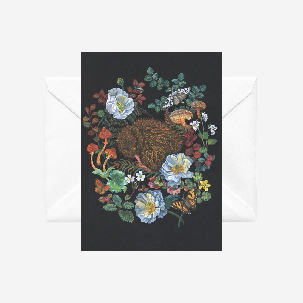 Greeting card with a kiwi surrounded by alpine flowers on a black background, with a white envelope, by Tanya Wolfkamp