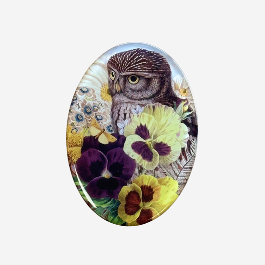 Oval fridge magnet with pansies and a ruru by Tanya Wolfkamp