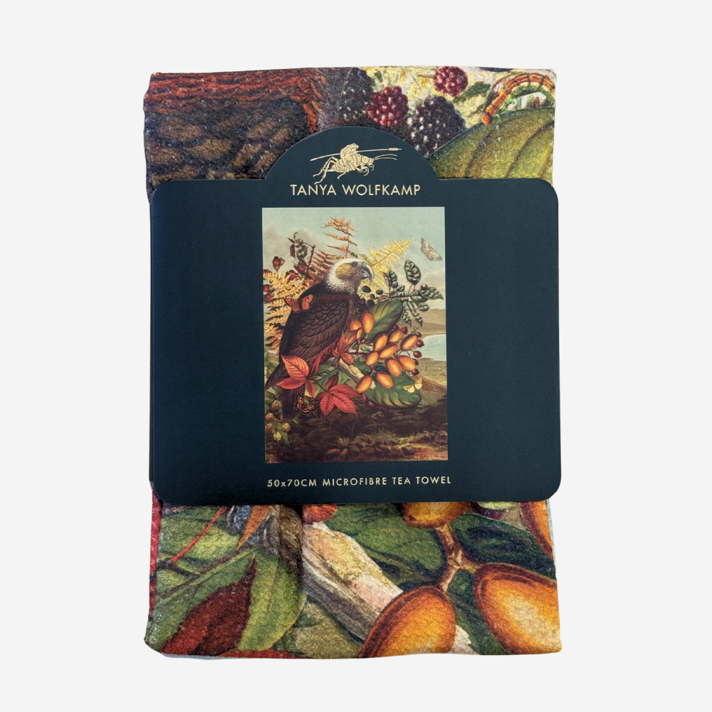 Packaged tea towel with botanical design and Tanya Wolfkamp branding on a white background