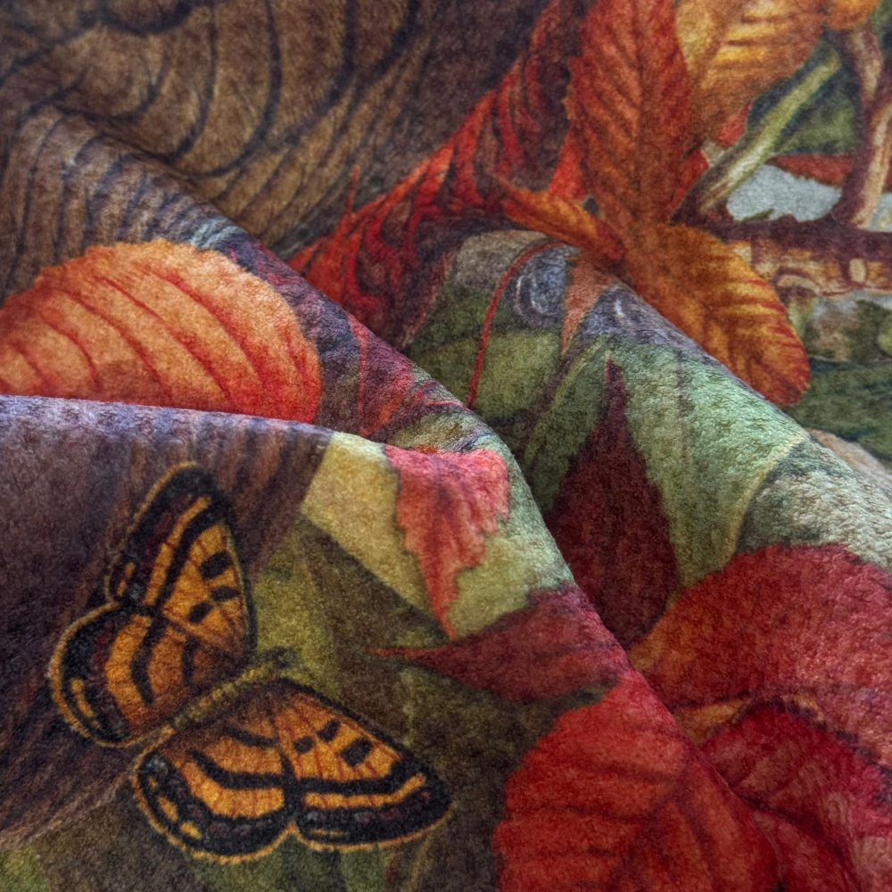 Close-up of a textured fabric with butterfly and leaf patterns