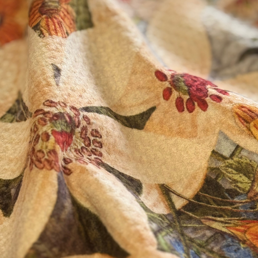 Close-up of a fabric with floral and bird patterns