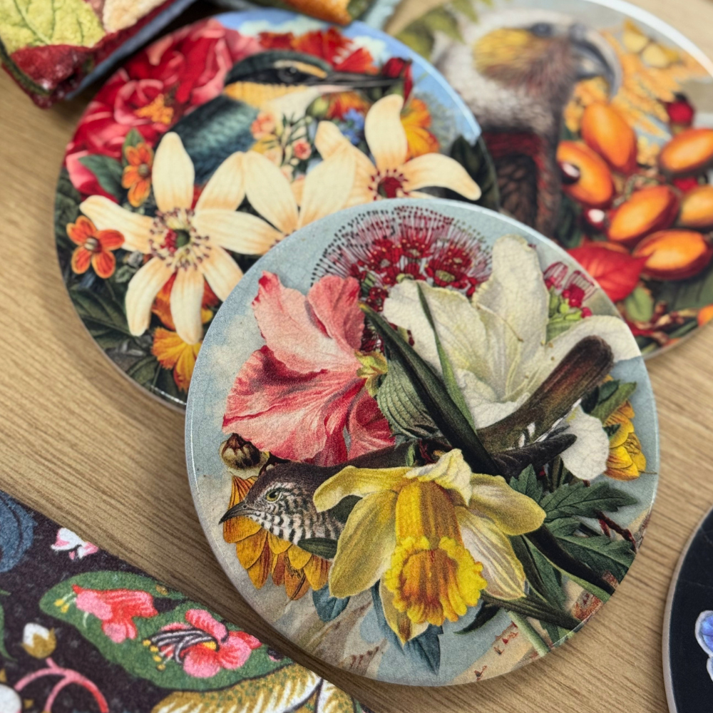 Decorative coasters with floral designs on a wooden surface